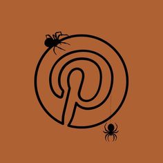 a black spider sitting on top of an orange wall next to a brown sign with the letter p