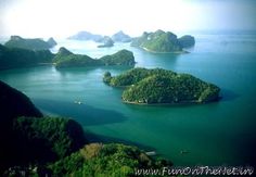 an aerial view of several islands in the ocean with green trees and bushes around them