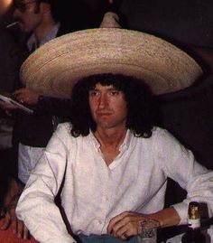 a man wearing a sombrero sitting at a table