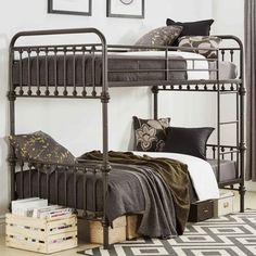 a metal bunk bed sitting in a bedroom next to a rug and pictures on the wall