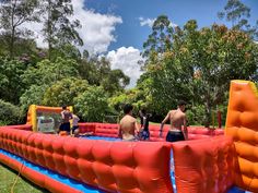 some people are playing in an inflatable pool