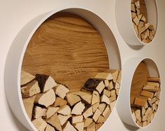 several pieces of wood are arranged in the shape of circles on a white wall mounted shelf