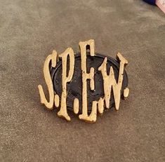 a wooden sign that says spew on the sand