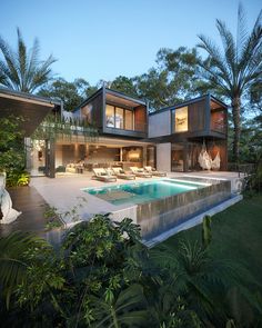 a house with a swimming pool in front of it and palm trees around the pool