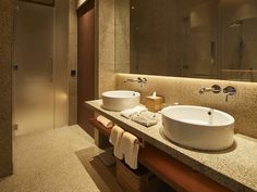 a bathroom with two sinks and mirrors in it