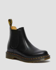 The Original DM's Chelsea boot. The 2976 dates back to the 70s and has a long-running heritage of music and mayhem. Here the classic silhouette returns in our classic Smooth leather, enhanced with yellow welt stitching and a scripted AirWair heel loop. The Chelsea boots sit on a robust air-cushioned sole, as they have since the start. The 2976 is the rugged Docs take on the classic Chelsea boot. Manufactured since the 70s Pull-on style, with elastic gussets Serves up all the signature Doc’s ... Doc Marten Chelsea, 2976 Chelsea Boots, Back To The 70s, Dr Martens 2976, Yellow Heels, Chelsea Boots Women, Black Chelsea Boots, Leather Chelsea Boots, Chelsea Boot