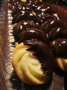 chocolate covered cookies sitting in a plastic container