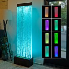 an illuminated water fountain in the corner of a room