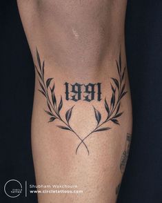 a man's leg with a tattoo on it and the number 999 written in black ink