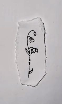 a piece of paper with the word love written on it and a flower drawn in black ink