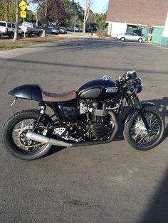 a black motorcycle parked in a parking lot