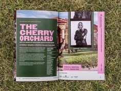 an open magazine on the grass with a photo of a man and dog in it