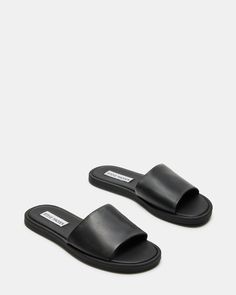 CHILL + SLEEK + CLEAN A monochrome design and a wide strap gives the flat KAYA slide its classic look. Slide sandal Slip-on style .5 inch heel height Leather upper material Synthetic lining Synthetic sole Imported Sandals Aesthetic, Steve Madden Slides, Sandals Steve Madden, Basic Sandals, Steve Madden Store, Steve Madden Sandals, Perfect Closet, Black Slides, Monochrome Design