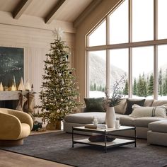 a living room filled with furniture and a christmas tree in front of a large window