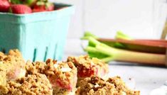 the dessert is ready to be eaten on the table with strawberries and celery in the background