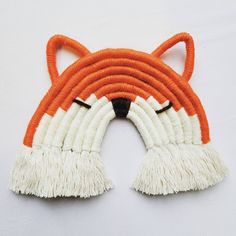 an orange and white tiger head with tassels