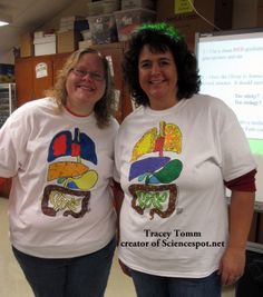 two women standing next to each other in front of a projector screen wearing t - shirts