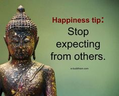 a buddha statue sitting in front of a green wall with a quote on it that says, happiness tip stop expecting from others