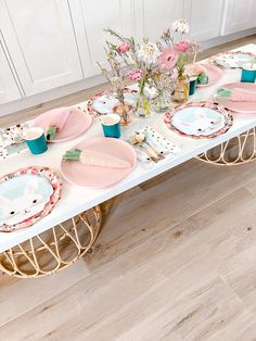 the table is set with pink and blue plates