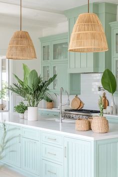 a kitchen with green cabinets and plants in baskets on the counter top, along with two hanging lights