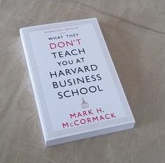 a book sitting on top of a bed next to a white sheet with writing that reads, what they don't teach you at harvard business school