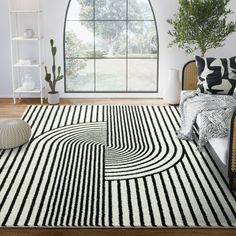 a room with a black and white striped rug on the floor next to a window