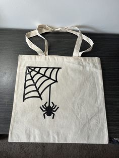 a white bag with a spider web on it