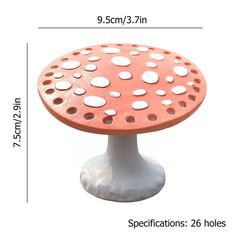 a white and orange mushroom shaped table with holes on the top, measurements for each piece