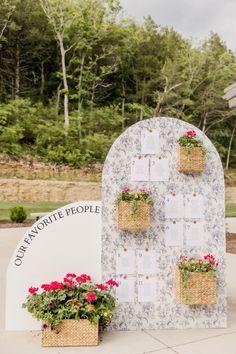 two flower pots with flowers on them are next to a sign that says, our favorite people