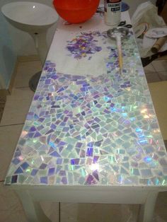 a table that has some kind of mosaic tile on it and is being worked on