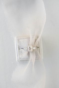 a white shirt with a bow tie and a diamond ring on it's lapel