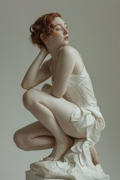 a woman in white dress sitting on top of a marble block with her hands behind her head