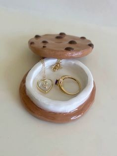 two pieces of jewelry sitting on top of a table