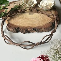 flowers are placed on top of a piece of wood