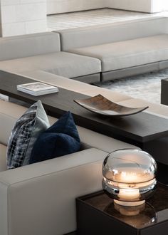 a living room filled with furniture and a large glass bowl on top of a coffee table