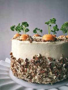 a cake decorated with carrots, nuts and parsley