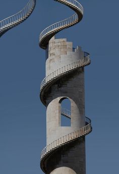 two spiral staircases going up to the top of a building