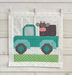 a piece of fabric with a green truck on it and polka dots around the edges