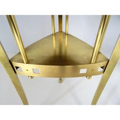 a gold metal chair with four legs