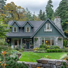 a house in the woods with lots of trees and shrubs around it, surrounded by greenery