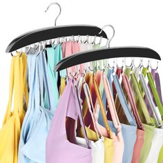 several umbrellas are hanging on hooks and hangers in the same color as each other