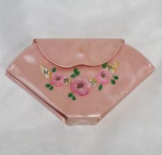 a pink plate with flowers and leaves on it