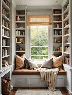 a window seat with bookshelves and pillows on it