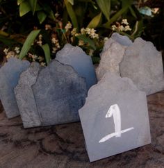 three rocks with the number one painted on them