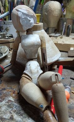 a wooden toy sitting on top of a table next to other woodworking tools and supplies