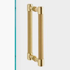 an image of two handles on a door with the handle in gold and the other in white