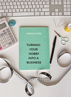 a notebook with the words turning your hobby into a business surrounded by various office supplies