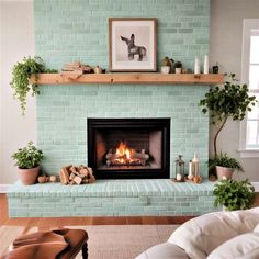 a living room filled with furniture and a fire place in front of a brick fireplace