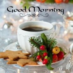 a cup of coffee sitting on top of a saucer next to cookies and berries