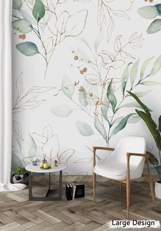 a chair and table in front of a wall with leaves on it